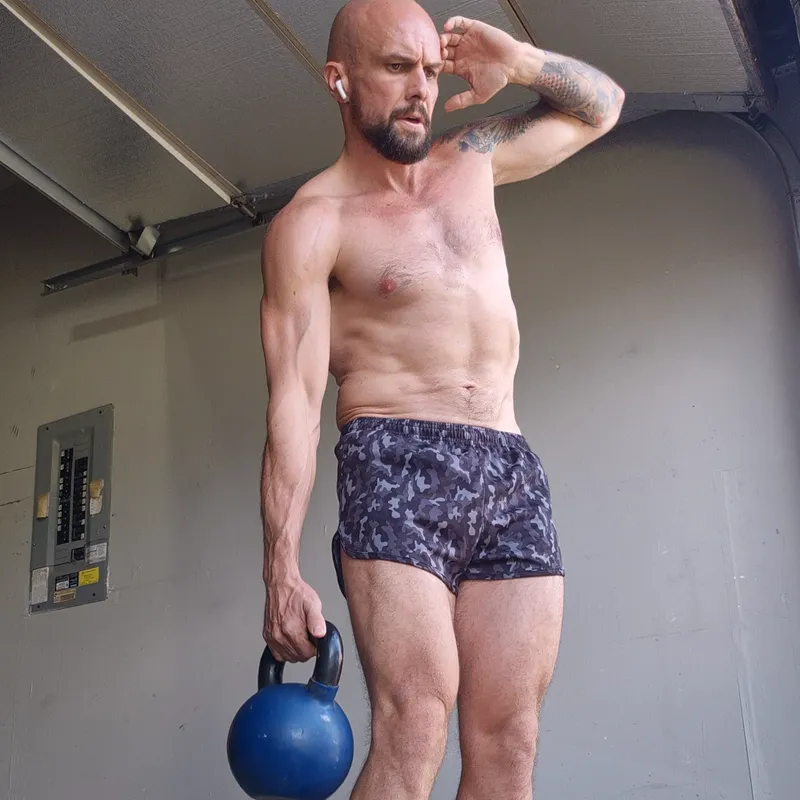 Standing side crunch holding a kettlebell in one hand