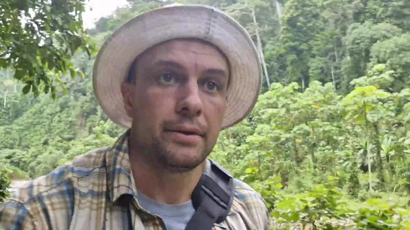 Josh in a bucket hat on the jungle trail beside the river near Dos Brazos, Osa Peninsula